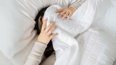 A woman suffering with a headache or migraine and looking for a solution in Calgary.